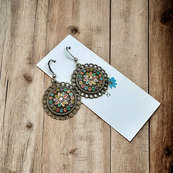 Boho enamel earrings styled with cozy fall outfit on neutral wood background