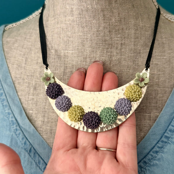 Bloom Garden Statement Necklace – Hammered Silver & Floral Crescent (Black Satin Ribbon)