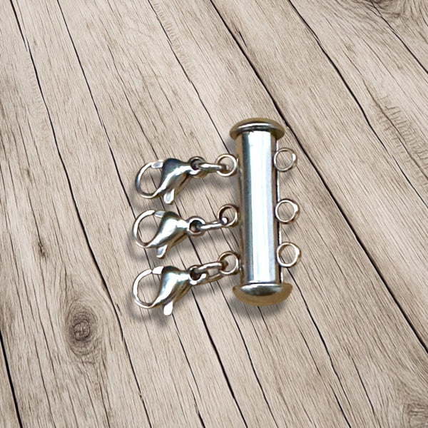 Layering magnetic tube clasp on a wooden surface