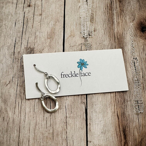 Minimalist Single hoop matte drop earrings with a wood background