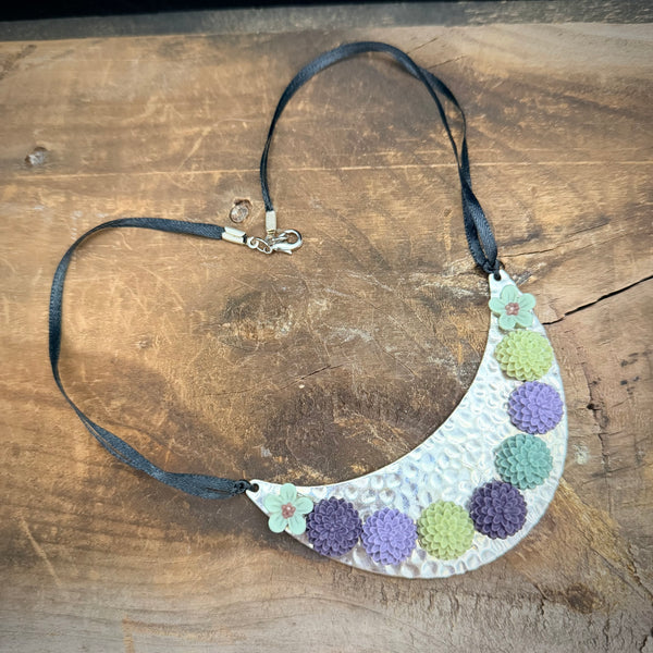 Bloom Garden Statement Necklace – Hammered Silver & Floral Crescent (Black Satin Ribbon)