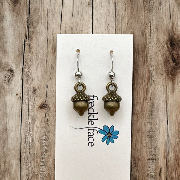 Antique brass acorn earrings on earring card