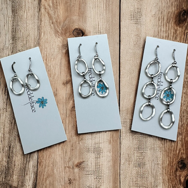 Minimalist circle wavy earrings on freckle face Jewellery brand card