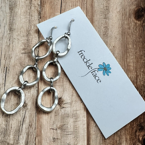 Three Matte silver oval texture dangle drop earrings with silicone secure backs