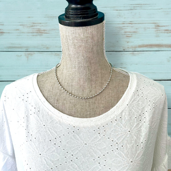 Modern ball chain necklace with 6 mm x 3 mm beads displayed flat