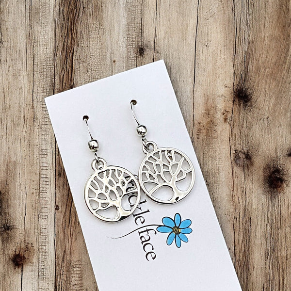 Close up of shiny silver family tree drop hook nickel free earrings