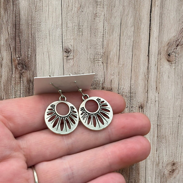 Matte silver dangle earrings shaped like abstract flower petals