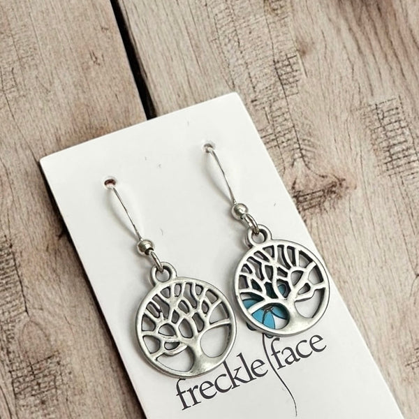Matte antiqur silver family tree drop hook earrings on wood backdrop