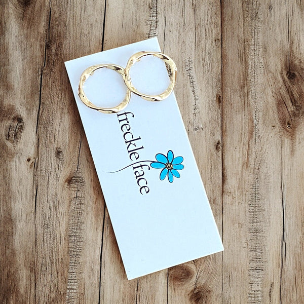 Minimalist gold-tone twisted studs on product card