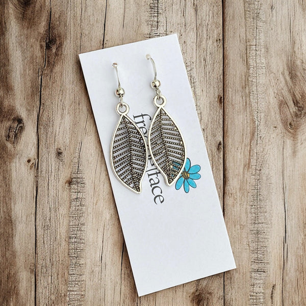 Lightweight antique silver leaf earrings with silicone stoppers displayed