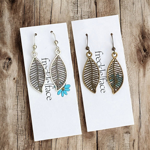 Filigree leaf dangle earrings in antique silver on Freckle Face Jewellery card