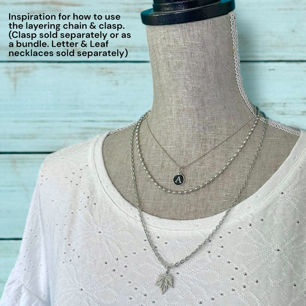 Mannequin wearing a triple layered necklace with with the layering clasp to avoid tangling