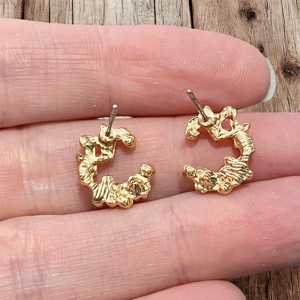 The backs of the pink and orange floral vintage stud earrings