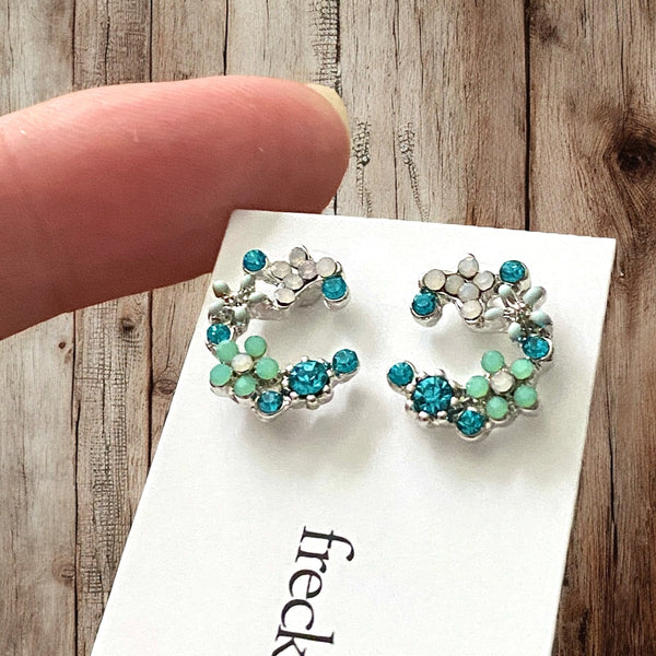 Pretty aqua and turquoise floral design studs with rhodium plating and silicone backs
