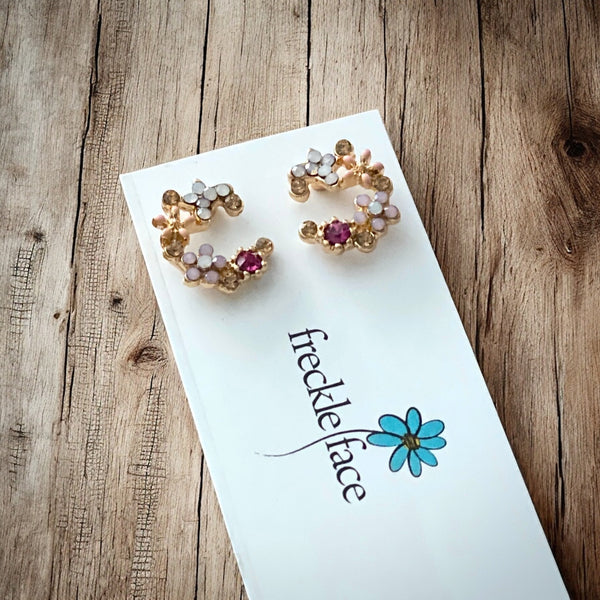 Crescent bloom stud earrings in gold plating with sparkly tiny glass stones in pink, white and orange.