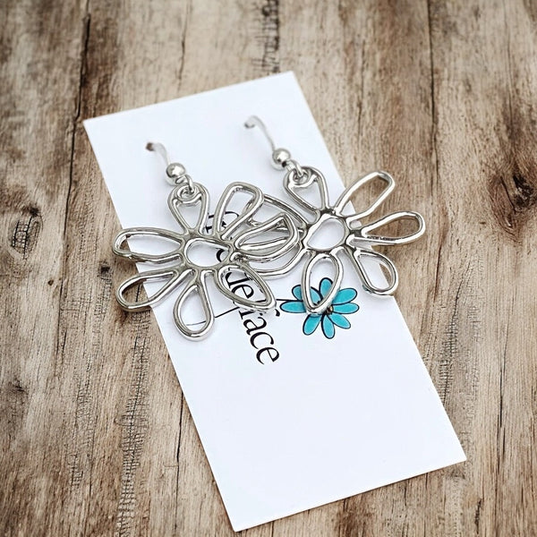Close-up of hypoallergenic matte silver abstract flower earrings