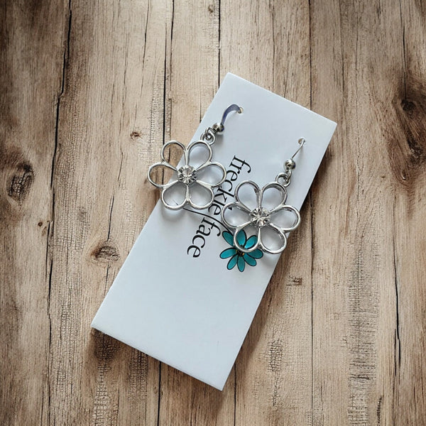 Handmade lightweight flower earrings hanging from rhodium hooks with silicone stoppers