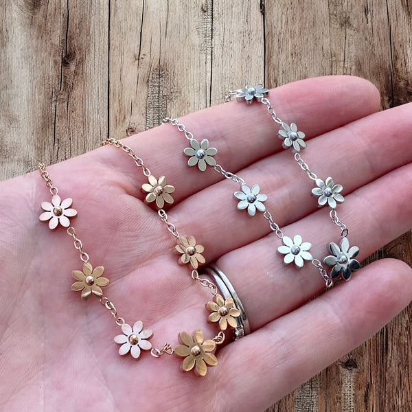 Close-up of etched flower detail on stainless steel anklet