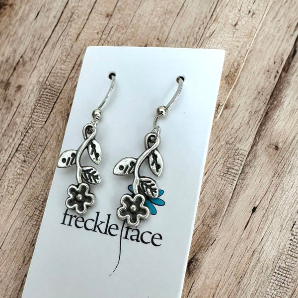 Antique silver wildflower vine earrings with intricate leaf details on Freckle Face earring card.