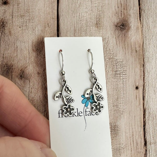 Boho-style silver wildflower earrings photographed close-up on Freckle Face Jewellery card.