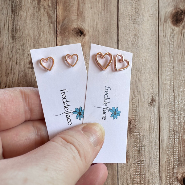 Mommy and Me matching open heart rose gold stud earrings on neutral background
