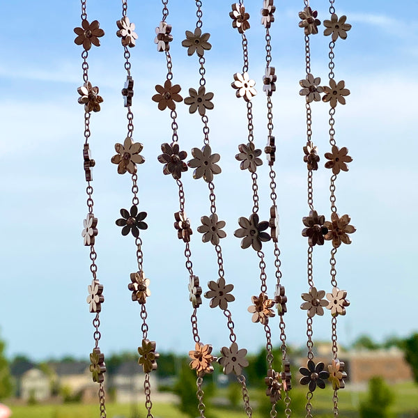 Photo of rose gold minimalist anklets hanging with the sky behind