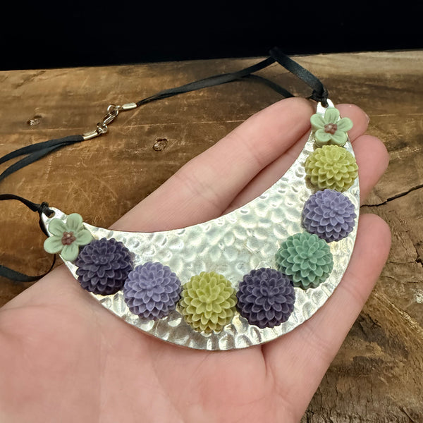 Bloom Garden Statement Necklace – Hammered Silver & Floral Crescent (Black Satin Ribbon)