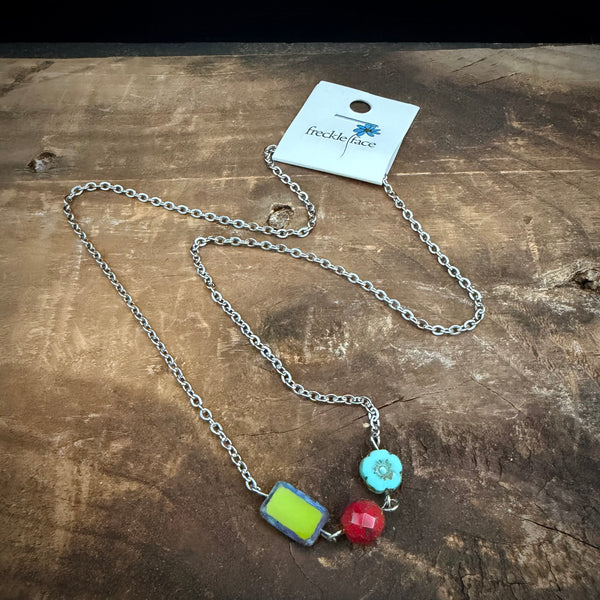 Colorful bead necklace with mixed shape Czech glass beads shown on rustic wood surface