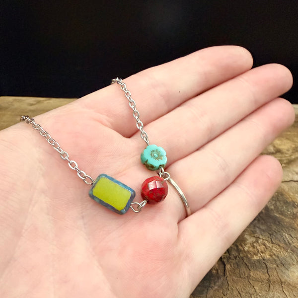 Colorful Czech glass bead necklace shown in hand to display bead size and detail