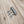 Stainless steel magnetic layering clasp with three lobster clasps on wood background