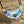 Bloom Garden Statement Necklace – Hammered Silver & Floral Crescent (Black Satin Ribbon)