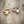 Adjustable daisy fidget ring with spinning charm on neutral background
